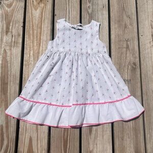 White floral toddler tress with a bow on the back.